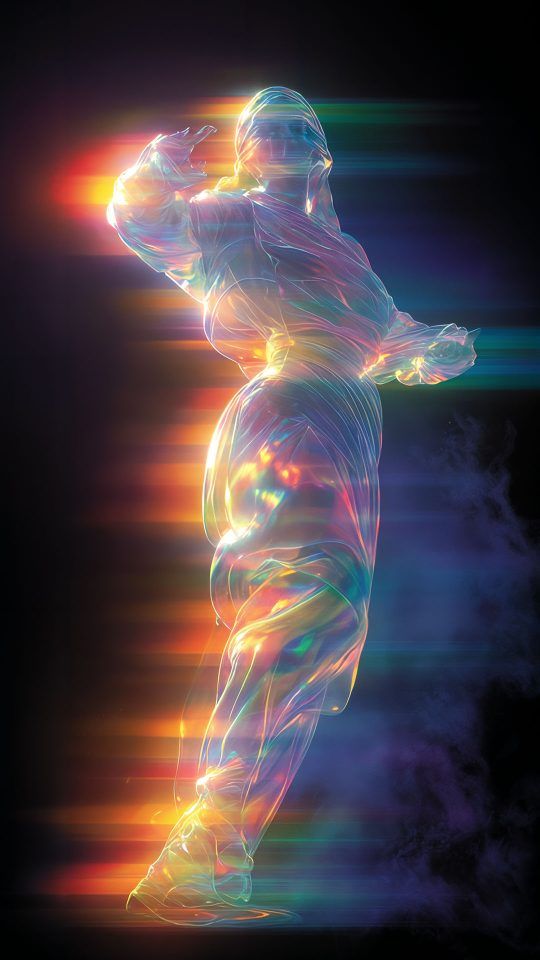 An abstract and translucent humanoid figure glows with iridescent, rainbow-colored light as it dances against a black background with colorful horizontal light trails.