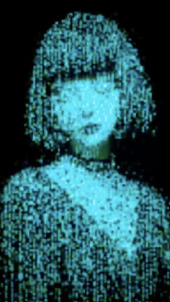 An animated video of a woman with short hair composed entirely of glowing green digital code against a black background.